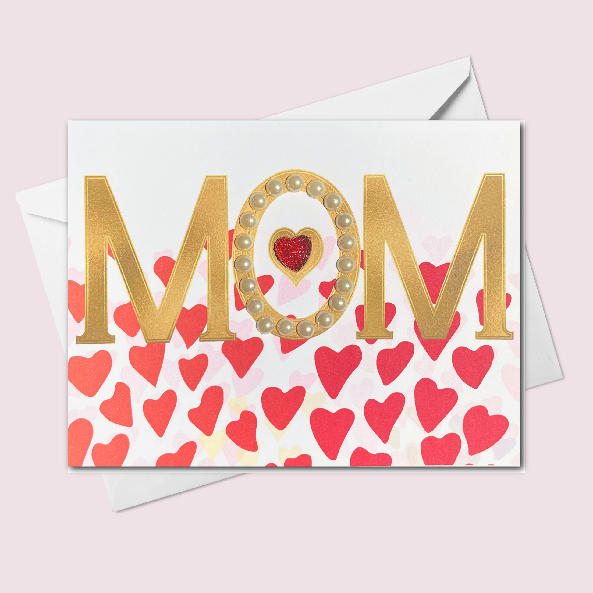 Handmade Mother's Day card featuring gold MOM letters with pearl accents, a glitter red heart, and a background of red and pink hearts, made in Canada.